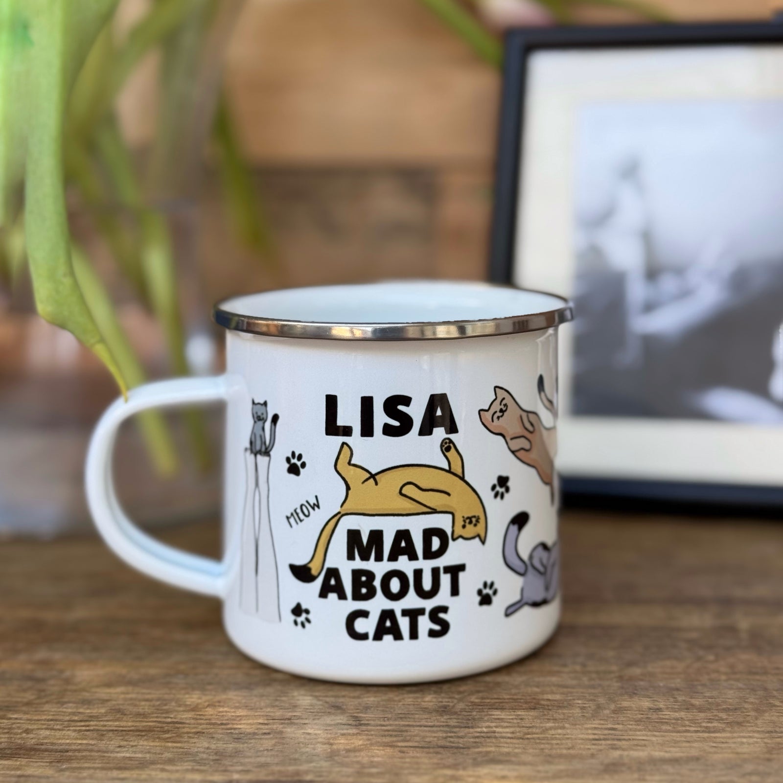 A tin mug with various cat illustrations and the text 'Mad about Cats'