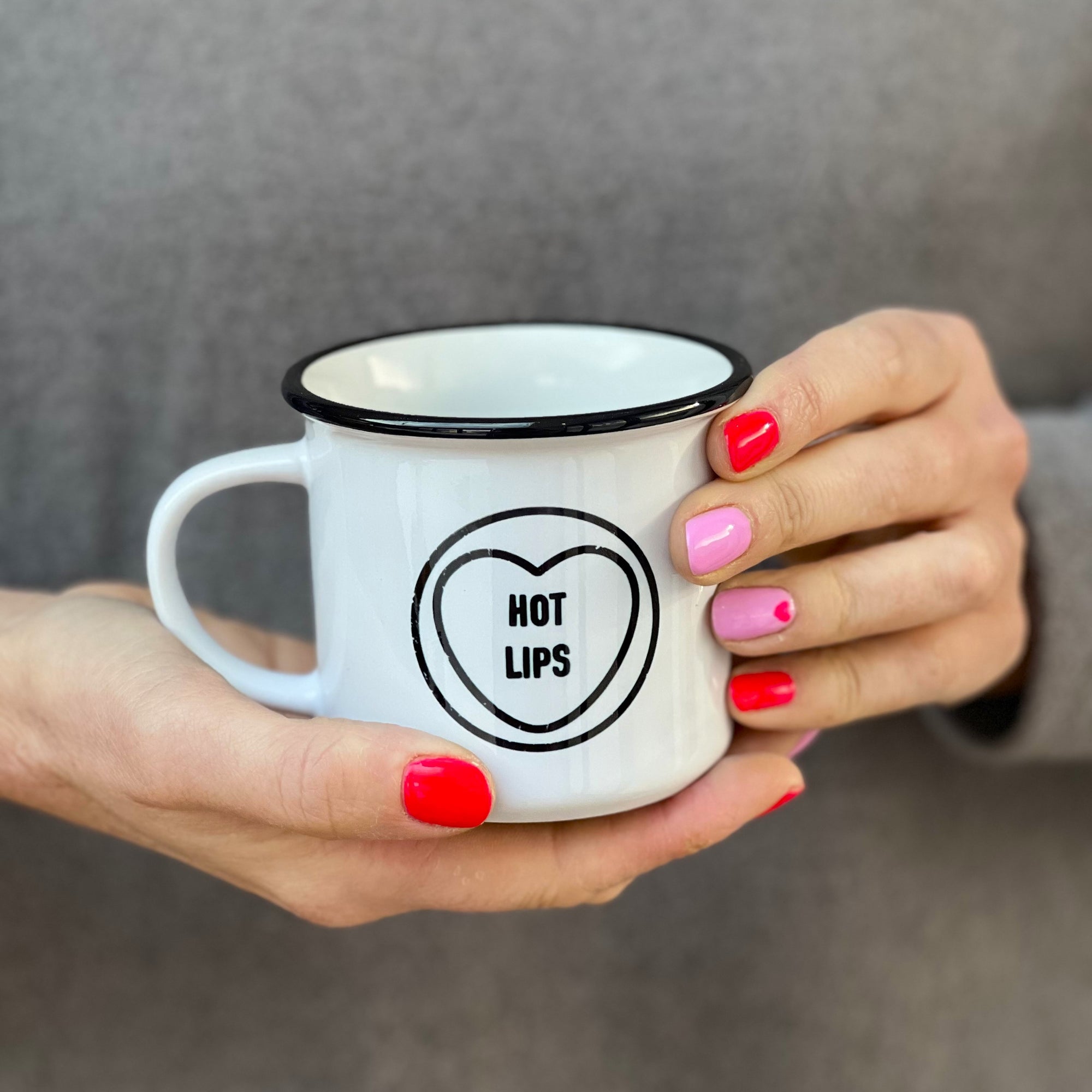 Lady holding black and White Hot Lips China Mug