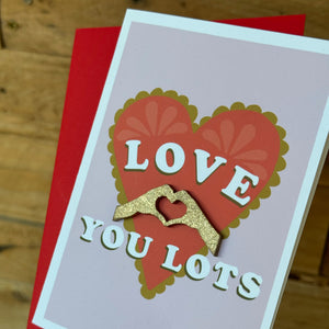 close up of 3D golden hands on a valentines card