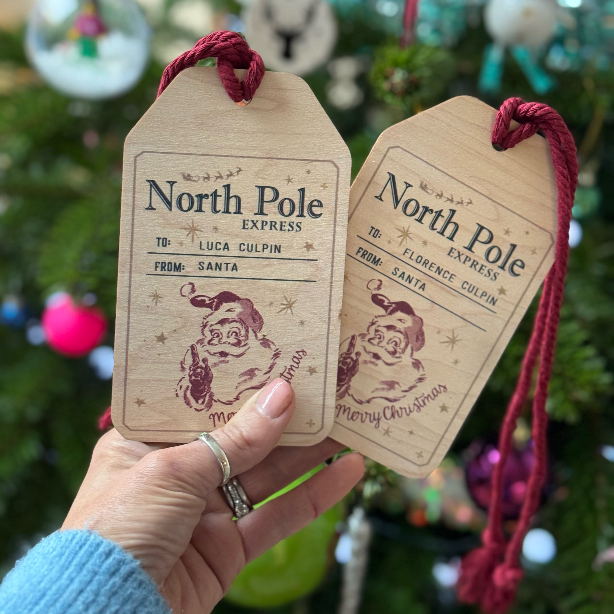 two wooden personalised name tags for Christmas sacks