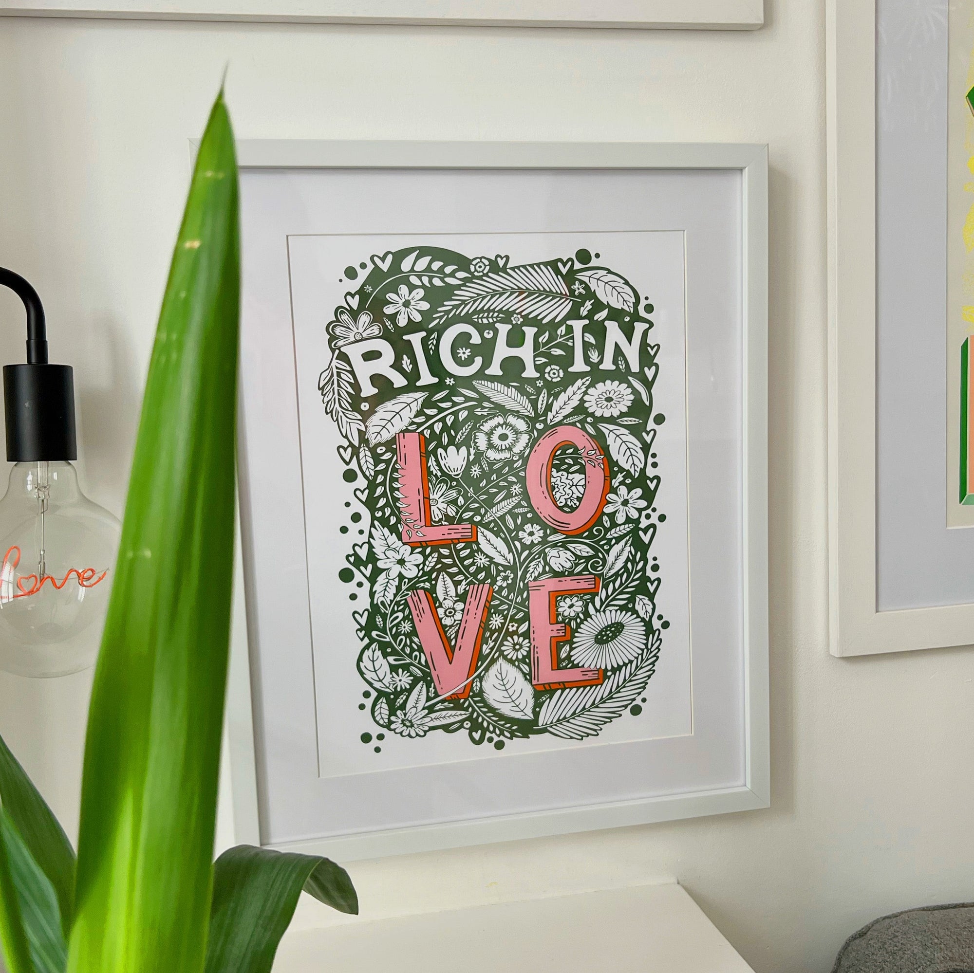 Rich In Love Print hanging on the wall 