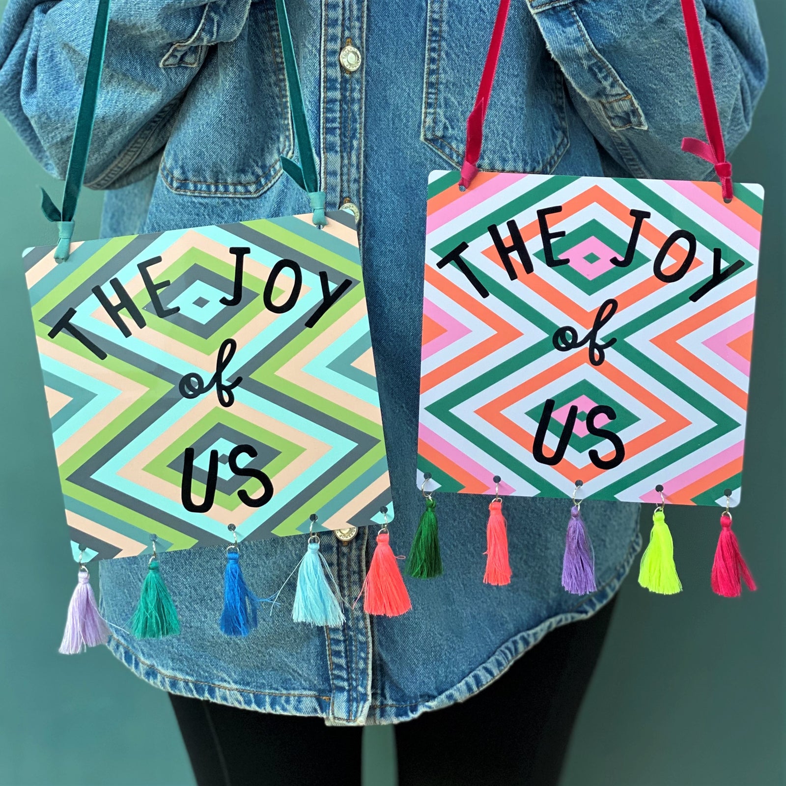 The Joy Of Us Tasselled Metal Sign Pink, Blue Green