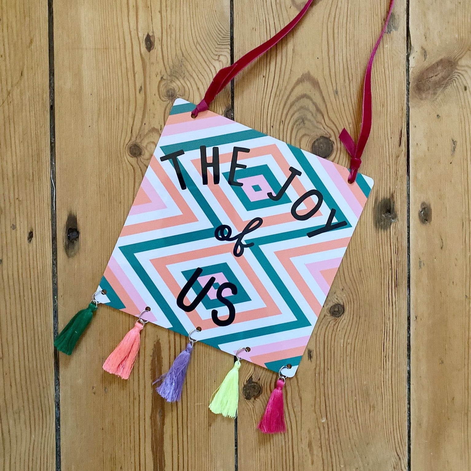 The Joy Of Us Tasselled Geometric Sign Orange And Pink